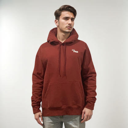 Man wearing a red hoodie with a logo on a plain background